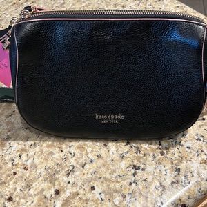 Kate Spade medium crossbody brand new. Tags attached. All Black with pink trim.